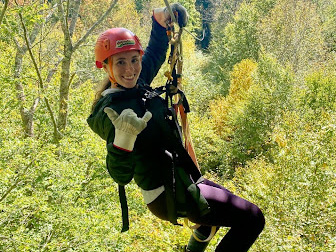 Rachael Savage on a zipline in the woods