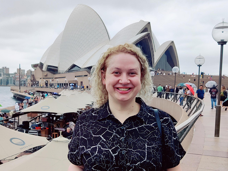 Margot Moser standing in front of the Sydney Opera House