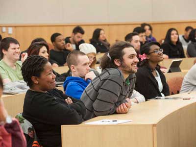 a large classroom full of engaged and smiling v.c.u. students