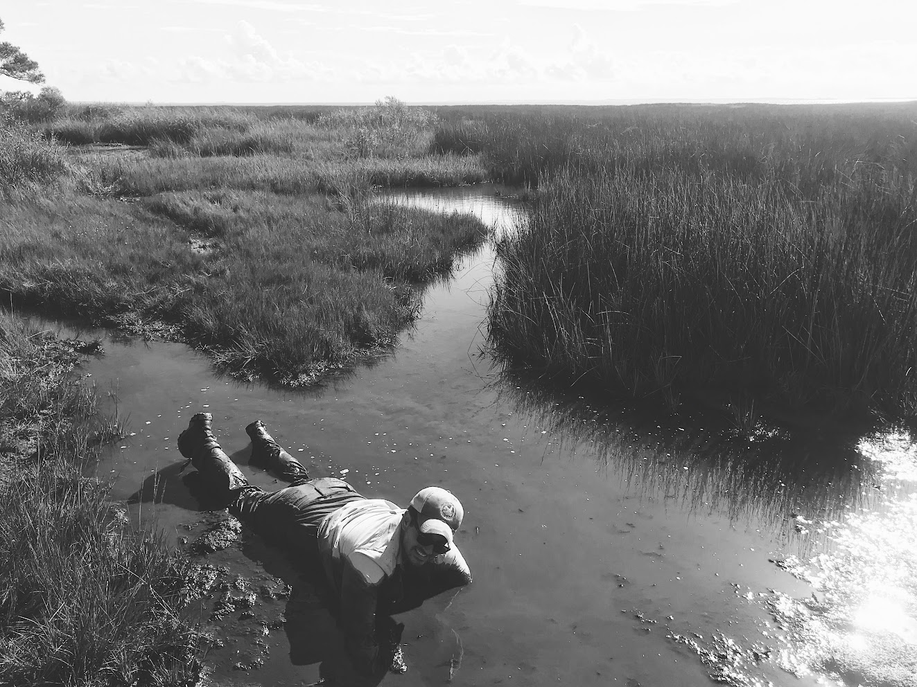 Adam Dunn laying in a creek