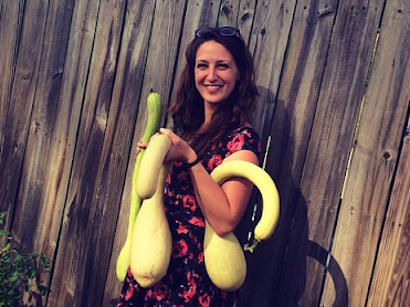Kelsey Cappiello holds three large gourds